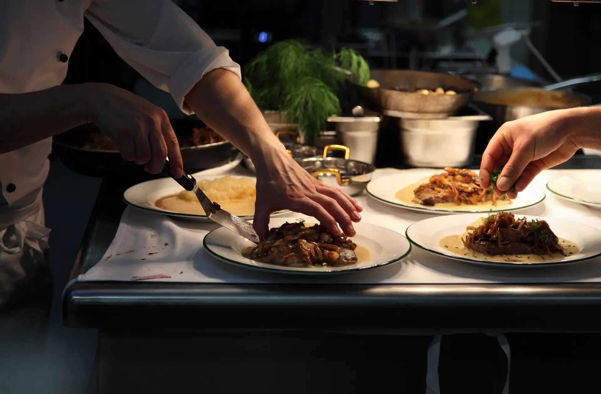 A chef meticulously plating a dish for a gala dinner